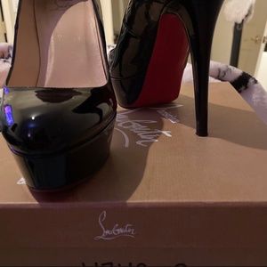 Ladies high heeled black patent pumps